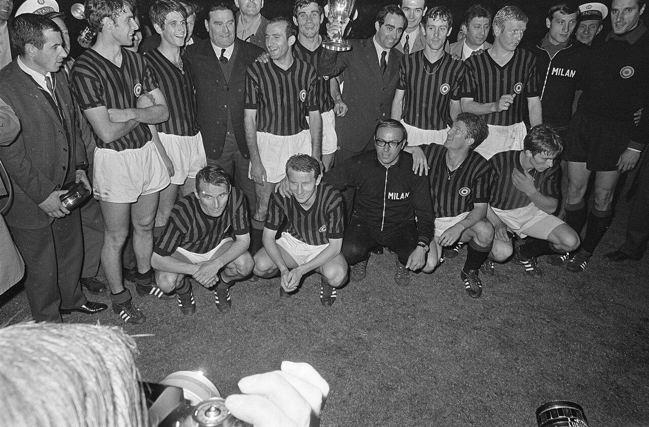 Milan pose with the Cup Winners' Cup after beating Hamburg 2-0 in Rotterdam, 23 May 1968 — the scudetto patch already on their shirts from the title sealed days earlier.
